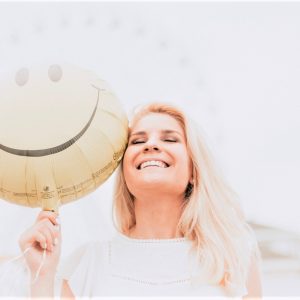 woman smiling with happy face balloon